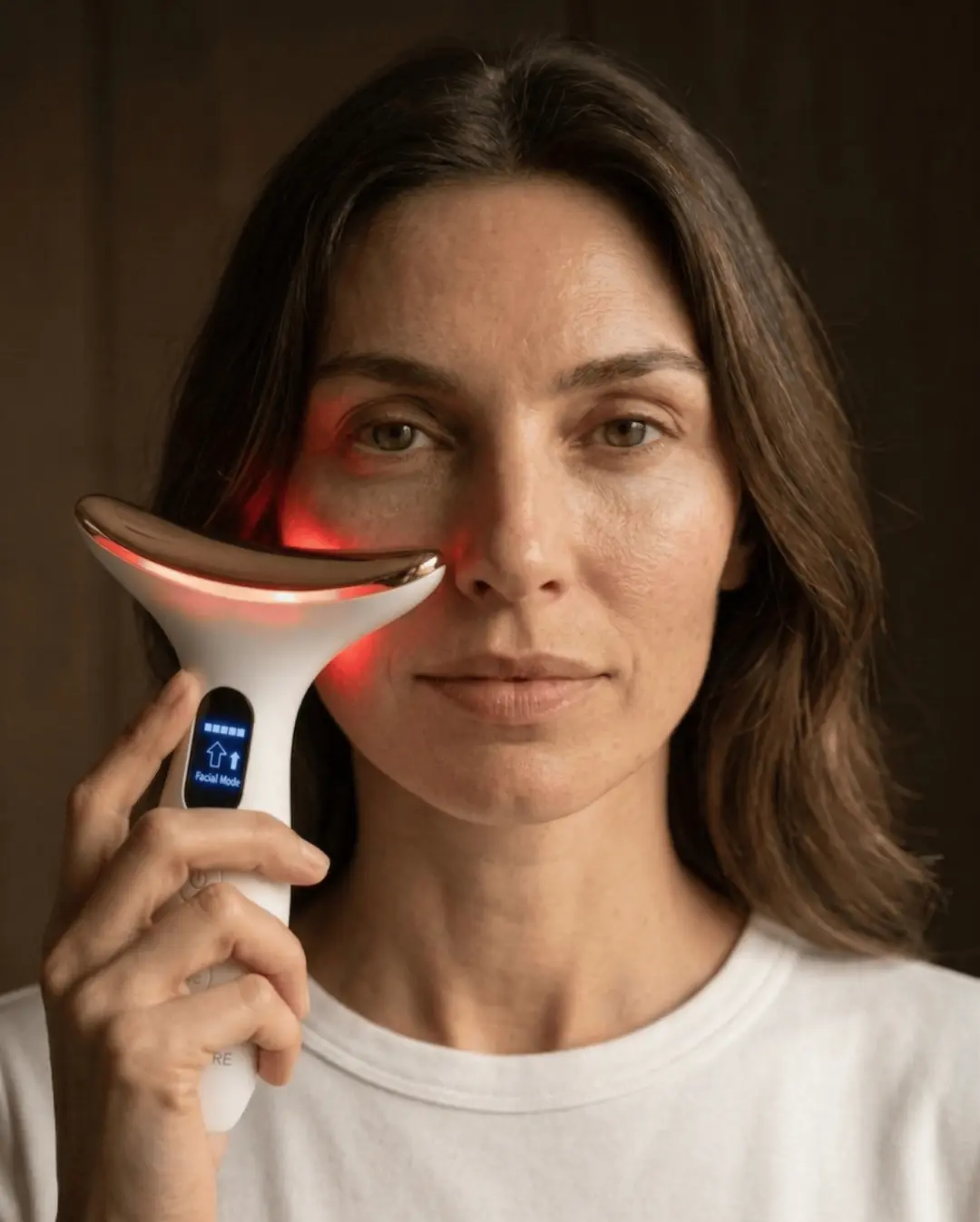The instrument gliding along the cheek, its light warm against the skin.